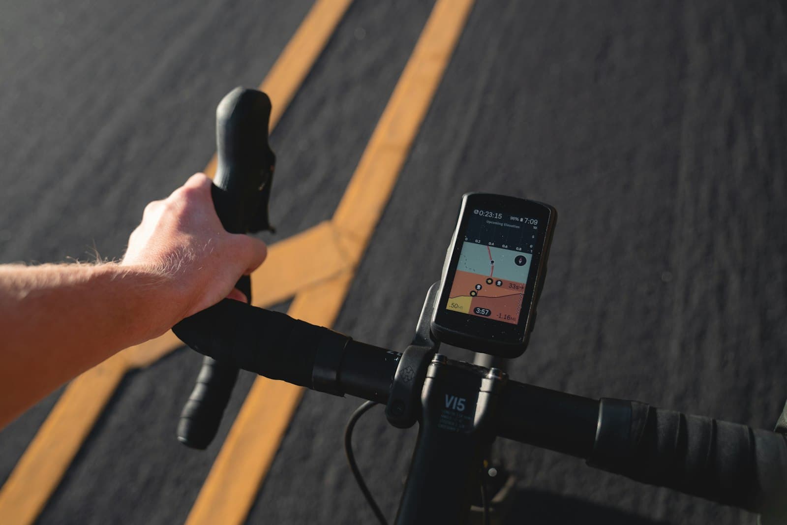 A cyclist's point of view riding through the city, with a GPS app running on a device mounted to the handlebars.